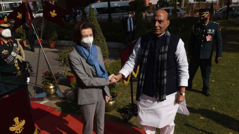 India's Defence Minister Rajnath Singh (R) greets his French counterpart Florence Parly