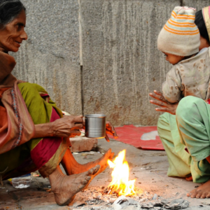 In cold winter' people warming themselves around fire