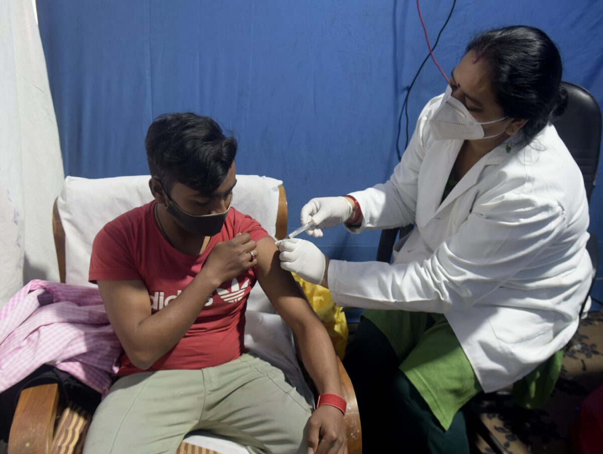 A health worker administers a dose of the Covishield vaccine -03